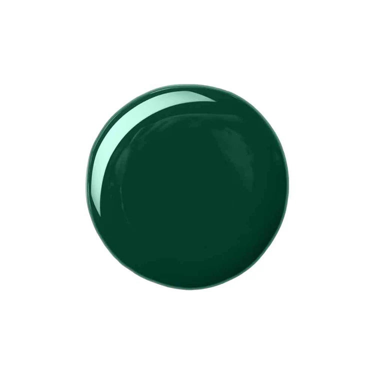 A glossy, circular swatch of deep forest green polish or paint on a solid white background.