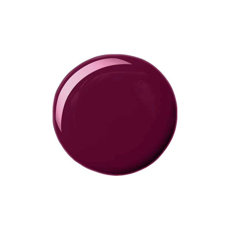 A glossy, circular swatch of deep burgundy nail polish on a solid white background.