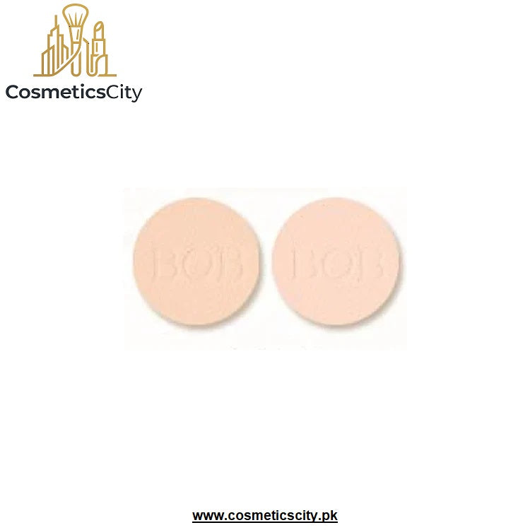 Two round beige makeup pans embossed with 'BOB' on a white background, with the CosmeticsCity logo in the top left and website text at the bottom.
