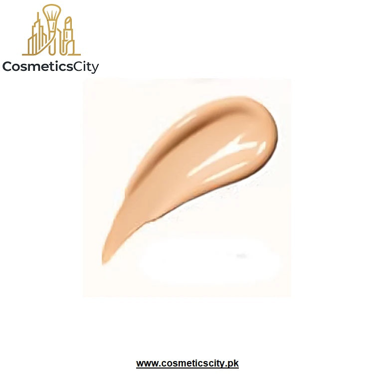 A swatch of liquid foundation or concealer in a warm light beige shade, shown as a glossy smear on a white background with the CosmeticsCity logo in the top left and website text at the bottom.