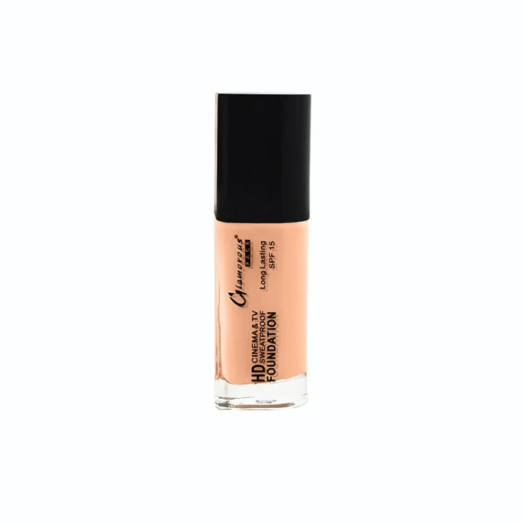 A bottle of Camille Clarysse HD Cinema & TV Foundation in shade SPF 15, showing the peach-colored liquid foundation through a clear glass bottle with a black cap, set against a plain white background.